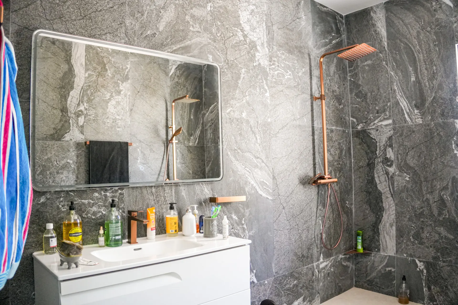 Marble bathroom with copper fixtures