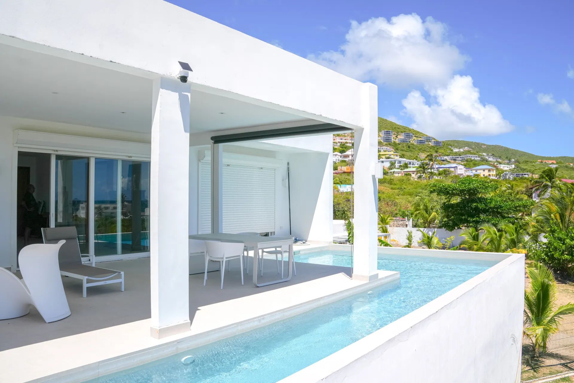 Villa Guanabay poolside terrace with hillside view